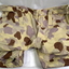 Pair of desert pattern pants and floppy hat.