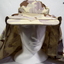 Desert pattern hat and pair of brown boots.