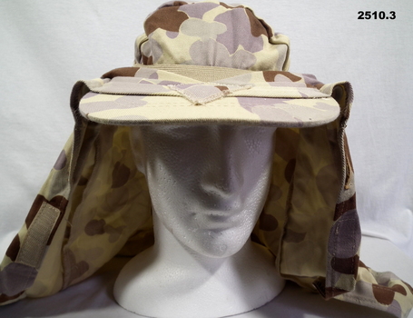 Desert pattern hat and pair of brown boots.
