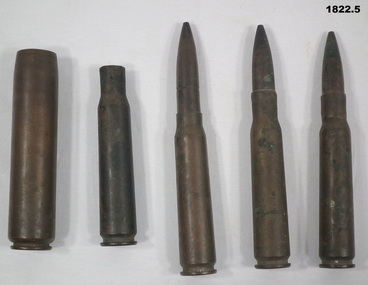 Five pieces of various ammunition rounds.