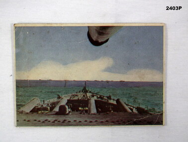 Coloured postcard showing the front deck of a warship.