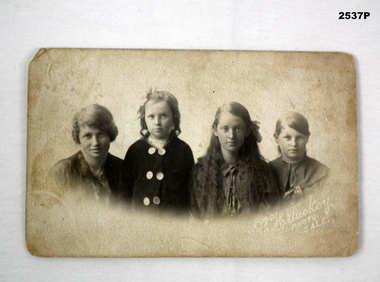 Post card photo showing four people.