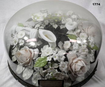 Glass dome with flower arrangement