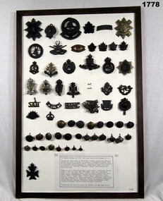 Framed with series of buttons and badges souvenired