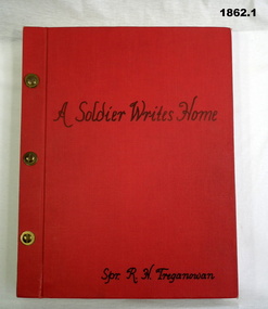 Red covered album with letters to home from Palestine.