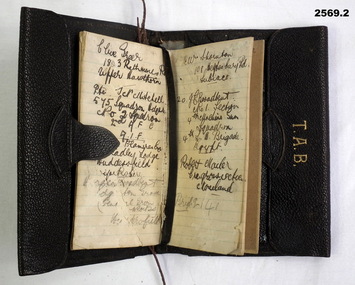 Initialled black wallet with attached note book