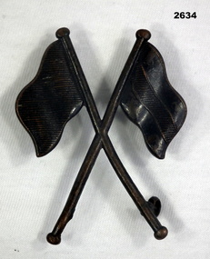 Crossed flags badge relating to Signals.