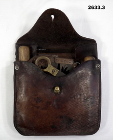 Leather pouch with roll out wood saw.