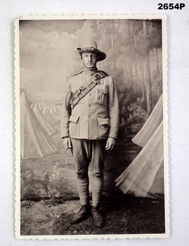 Sepia photograph soldier in studio setting.