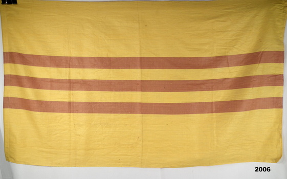 South Vietnamese flag with three horizontal red stripes on a yellow background.