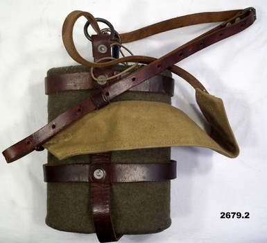 Water bottle with cover and leather carry straps.