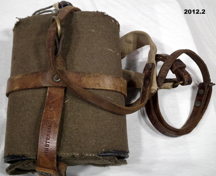Metal water bottle with cover and leather strap.