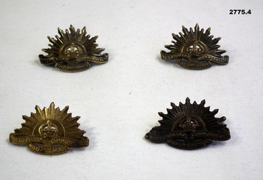 Four brass Rising sun collar badges.