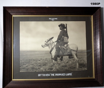 B & W photo of a soldier on a donkey.