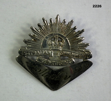 Trench art badge, rising sun & boomerang.