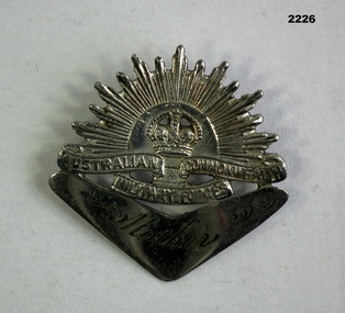 Trench art badge, rising sun & boomerang.