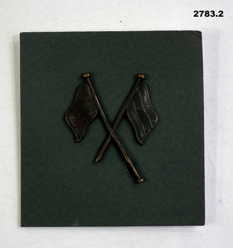 Two crossed flags denoting a Signal man.