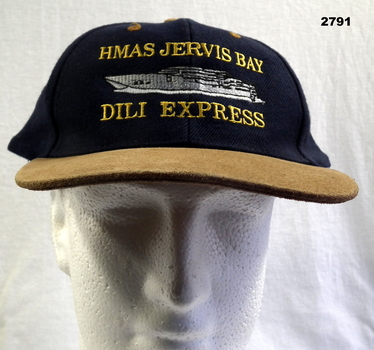 Peak cap with HMAS Jervis Bay on.