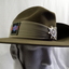 Slouch hat with two badges, colour patch & chin strap.
