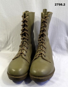 Pair of light khaki high sided lace up boots.