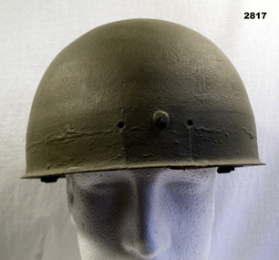 Green painted steel helmet similar to the type worn by paratroopers.