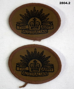 Two Khaki arm badges with Rising sun on.