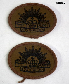 Two Khaki arm badges with Rising sun on.