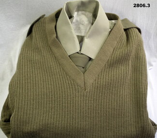 Khaki coloured jumper, shirt and tie.