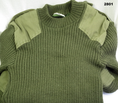 Green round neck jumper with shoulder pads.