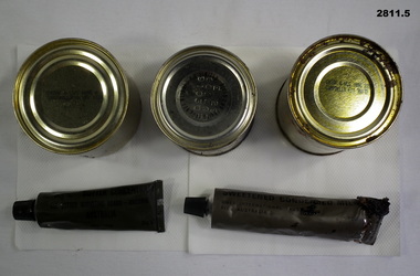 Three tins and two tubes from a ration pack.