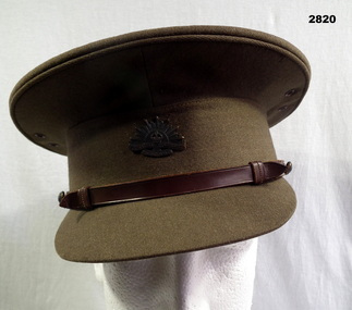 Khaki coloured Peak uniform cap.