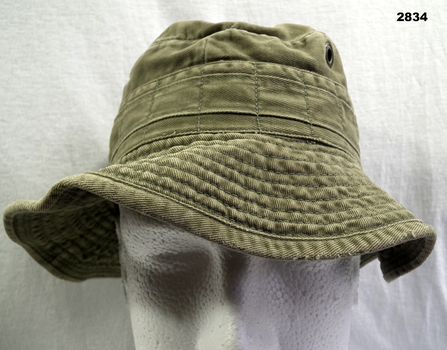 One green floppy bush hat.