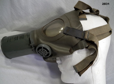 Gas mask complete with straps.
