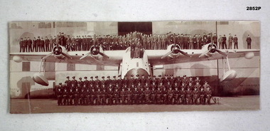 Photograph showing large group of men on a Sunderland aircraft.