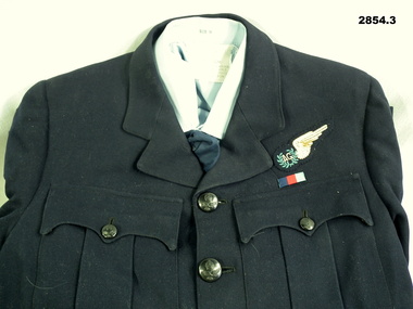 Blue RAAF uniform with Air Gunners insignia.
