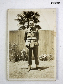 Photo of a WW2 soldier standing in gardens.