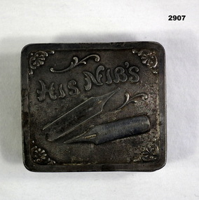 Square shape metal tin for ink nibs.