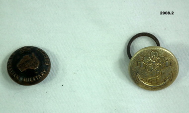 Two uniform buttons, one Australian, one unknown.