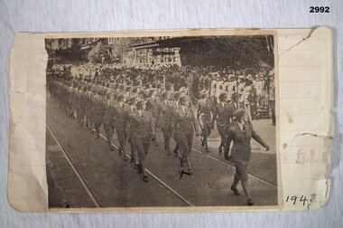 Newspaper cutting showing a group of Service women marching.