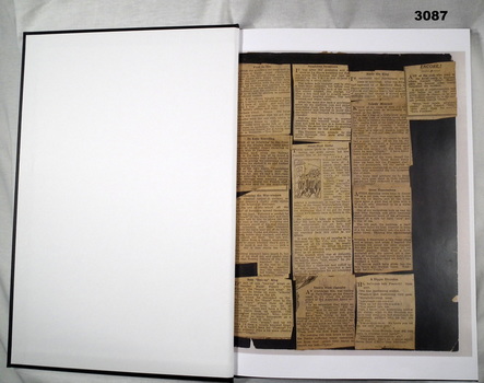 Hard cover book with newspaper cuttings in.