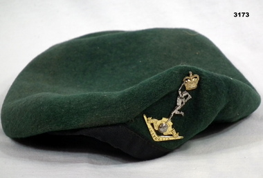 Green beret with a Signals badge.
