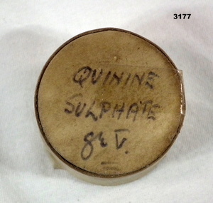 Small circular container with quinine tablets.