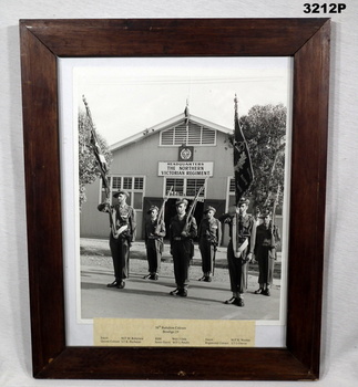 Photograph showing a parade in front of a Barracks.