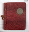 Small red photo album with photos over several countries.