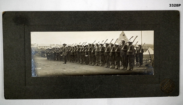 Photograph on card showing a parade of soldiers 1915.