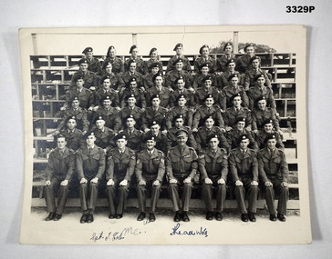 Photograph showing group of soldiers sitting.