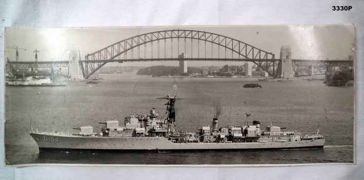 Photograph showing a RAN ship and the Harbour bridge.