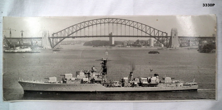 Photograph showing a RAN ship and the Harbour bridge.