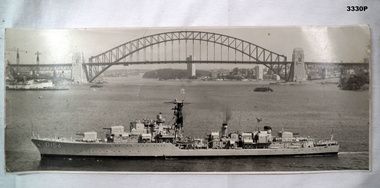 Photograph showing a RAN ship and the Harbour bridge.