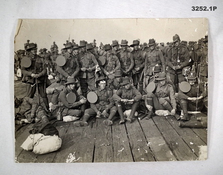 Three photographs re on board ship and trench.